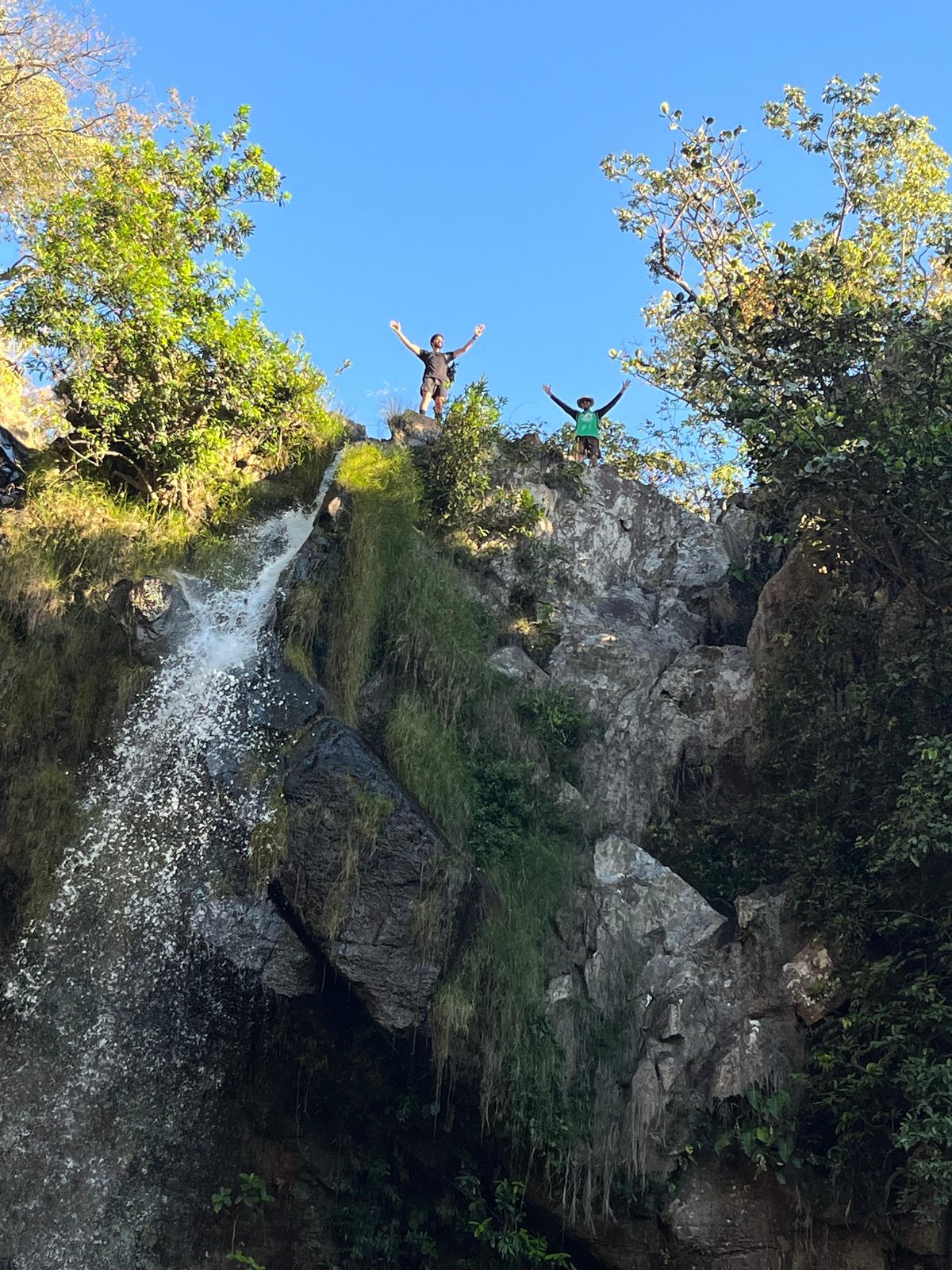 Aurélio and Nícolas atop a waterfall in Chapada dos Veadeiros